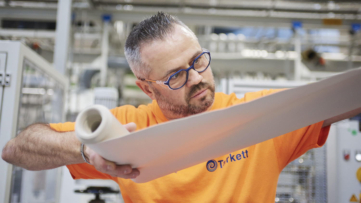 Operator manipulating a layer of material at our Wiltz R&D centre