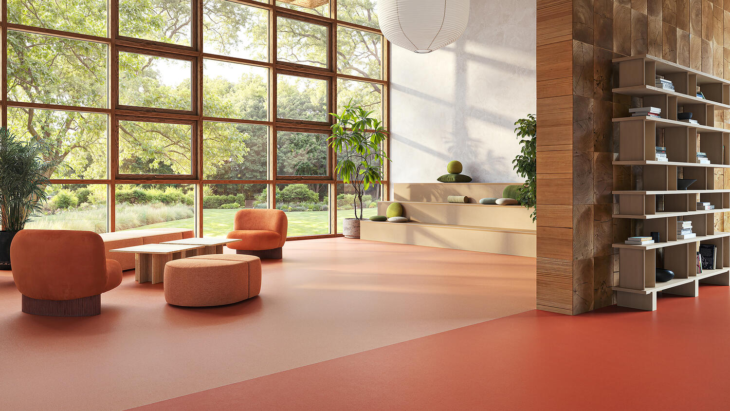 Una sala de espera con sillas, una mesa y estanterías. Los suelos crean diferentes espacios con pavimento de linóleo natural.