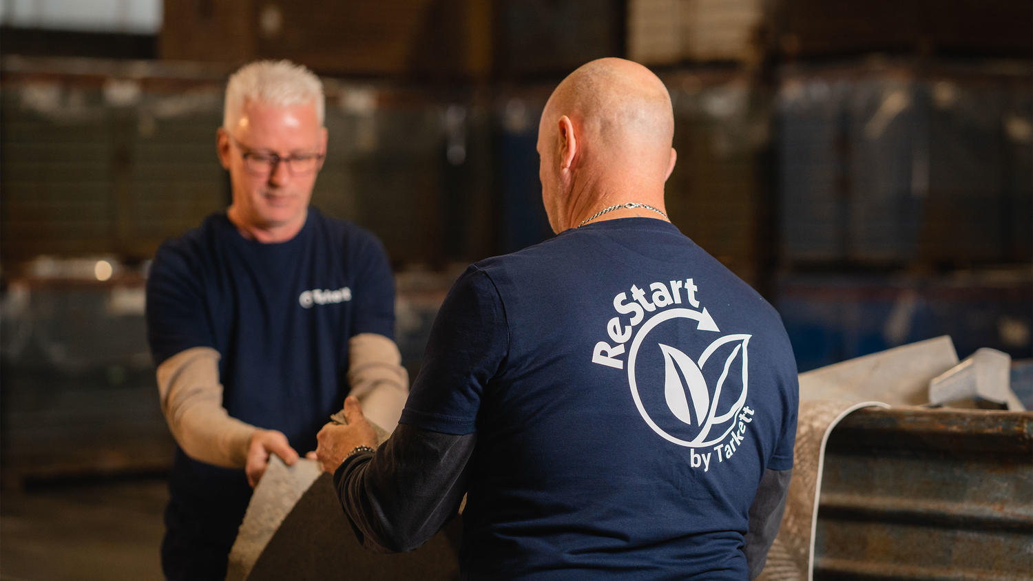 Two operators examining old vinyl floors at our recycling centre in Ronneby, Sweden