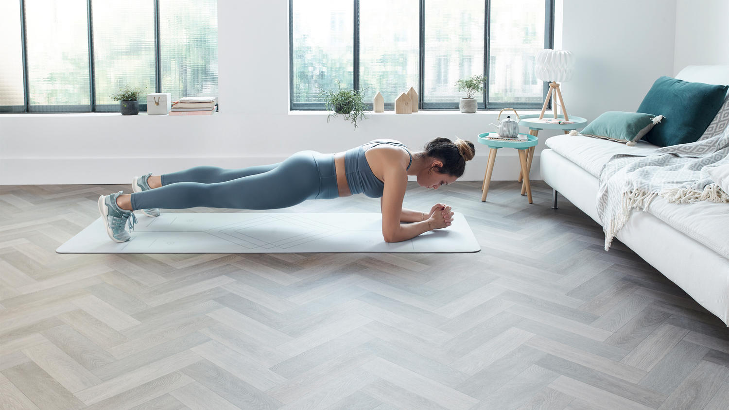 Young woman exercising in her living room