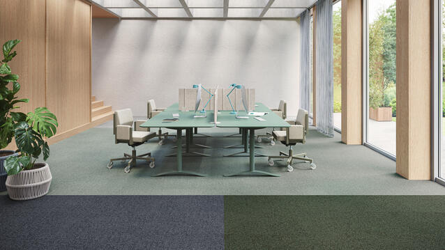Light-filled meeting room with DESSO Enlaced carpet tiles in light green, dark blue, and dark green, for modern workspaces